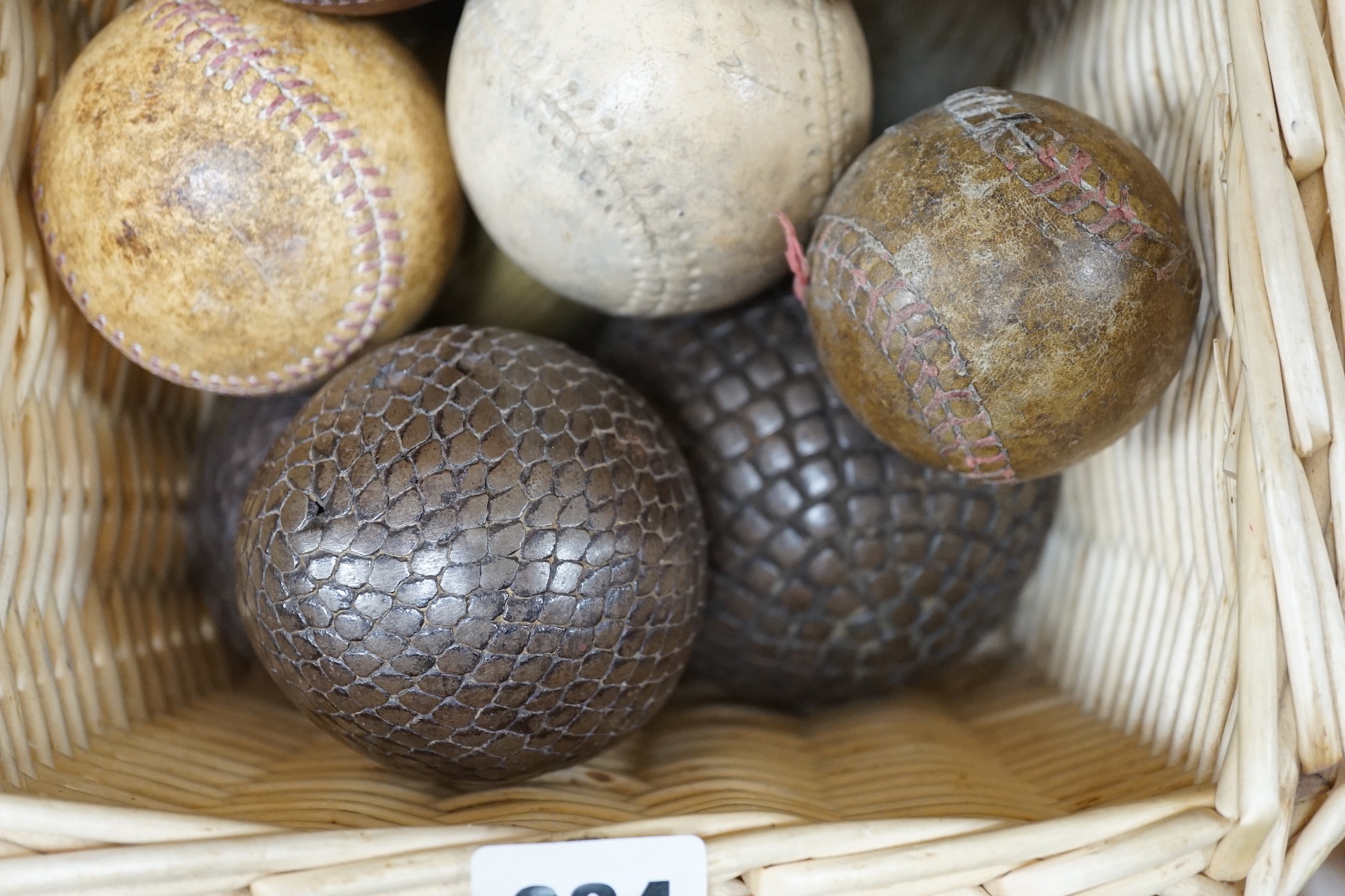 A collection of leather cricket and sporting balls